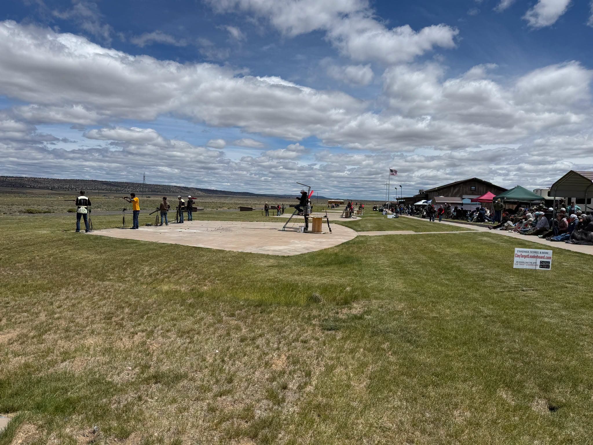 A squad shooting under big high-desert clouds at Bend